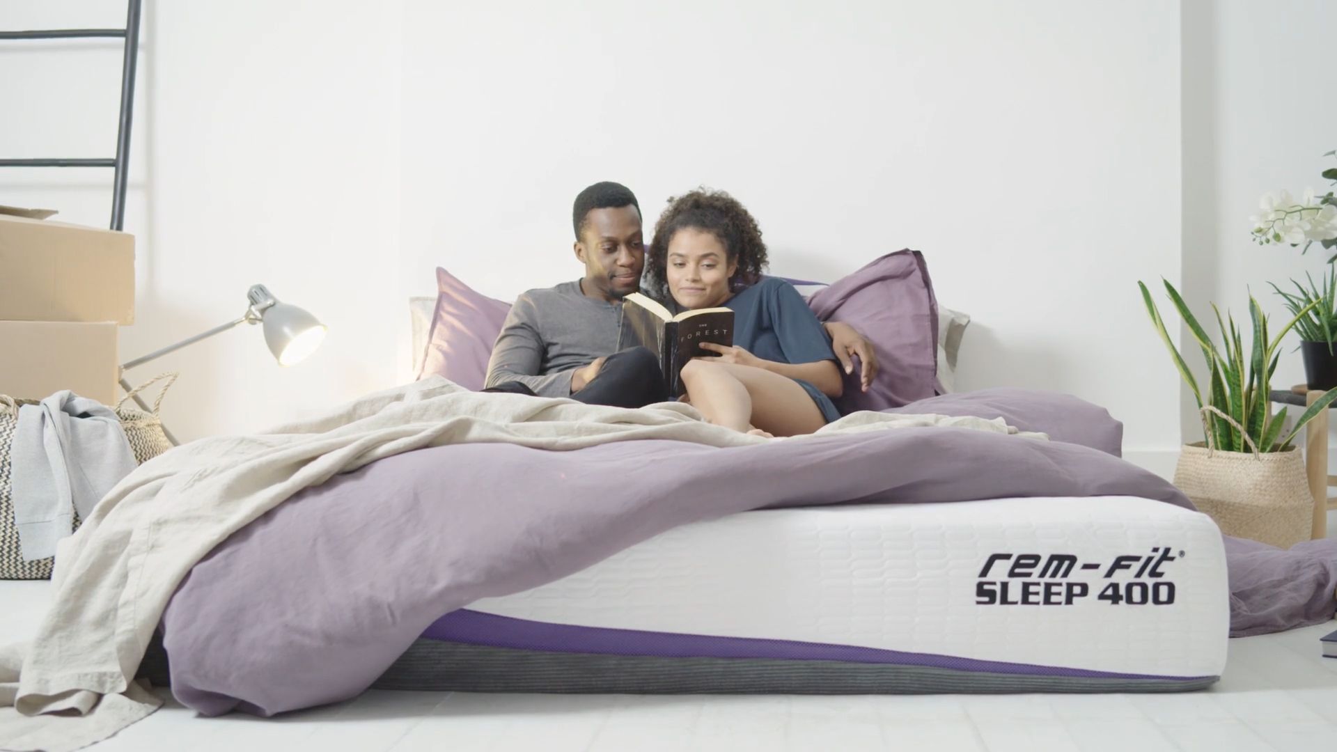 Couple reading together on mattress