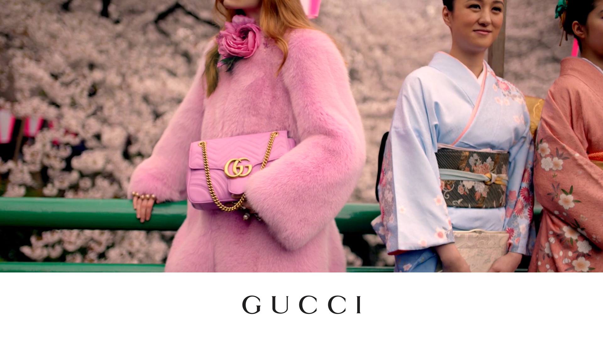 Photo of female holding pink gucci bag